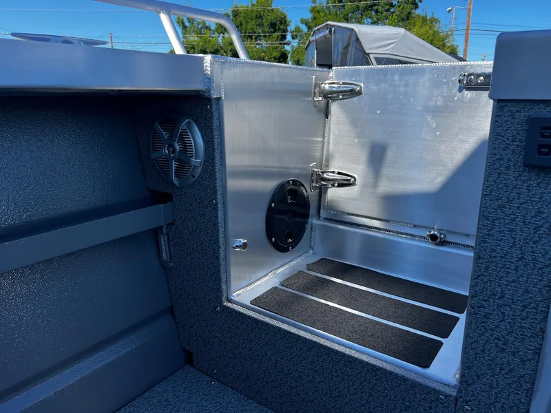 Slide: The Image of 2024 Thunder Jet 22 Alexis Pro boat interior, featuring storage compartment and speaker. - 27