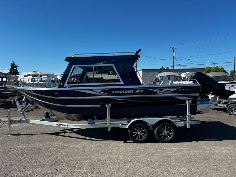 Slide: The Image of 2024 Thunder Jet 22 Alexis Pro boat on a trailer in a parking lot. - 3