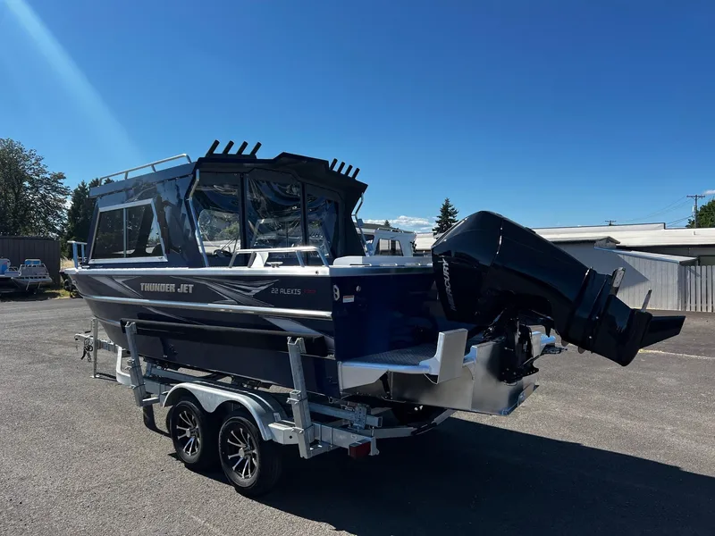 Slide: The Image of 2024 Thunder Jet 22 Alexis Pro boat on a trailer in a parking lot. - 4