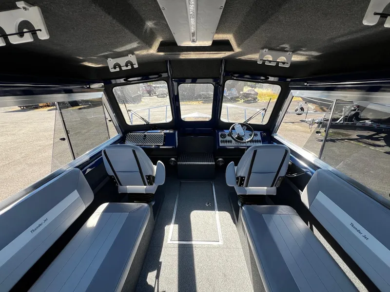 Slide: The Image of Interior of 2024 Thunder Jet 22 Alexis Pro boat with seating and steering console. - 9