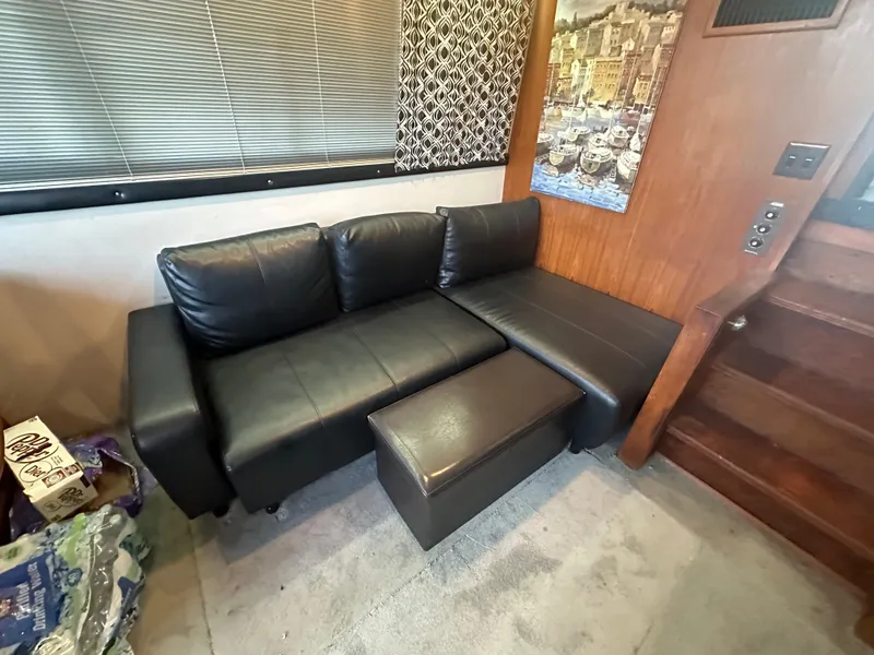 Slide: The Image of Black leather sofa in 1989 Carver 3807 Aft Cabin interior, near wooden stairs. - 18