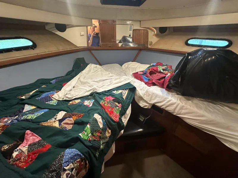 Slide: The Image of Interior of 1989 Carver 3807 Aft Cabin with colorful quilts on beds. - 25