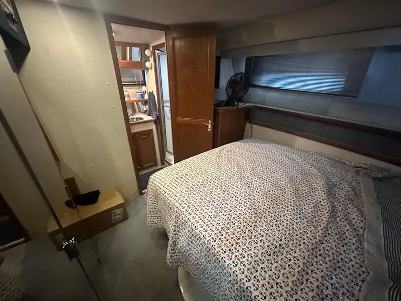 Slide: The Image of Interior of 1989 Carver 3807 Aft Cabin with cozy bedroom and bathroom view. - 30