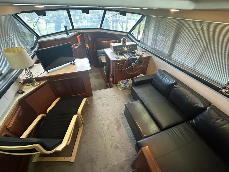 Slide: The Image of Interior of 1989 Carver 3807 Aft Cabin yacht with modern furnishings and helm station. - 13