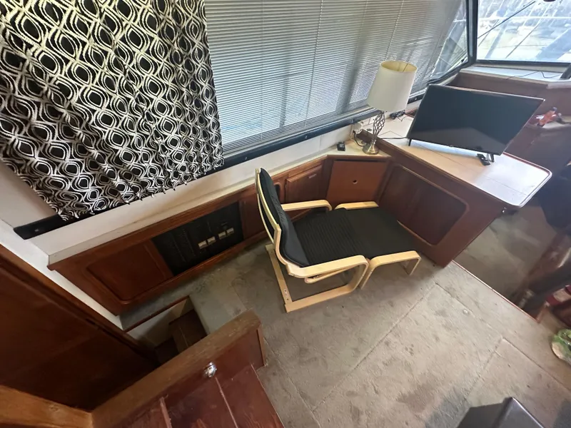 Slide: The Image of 1989 Carver 3807 Aft Cabin interior with chair, desk, and window blinds. - 15