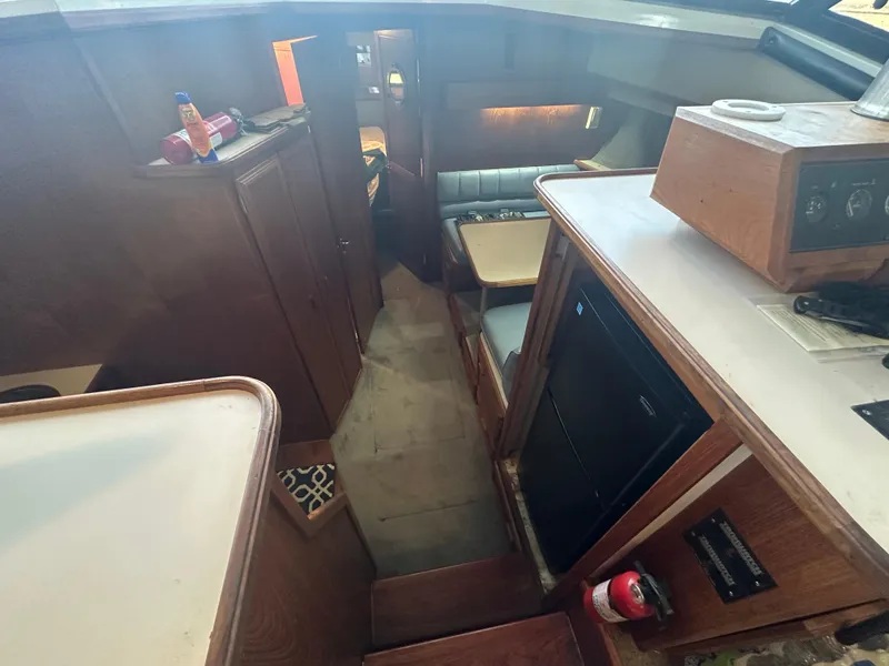 Slide: The Image of Interior of 1989 Carver 3807 Aft Cabin yacht, featuring wood cabinetry and seating area. - 19