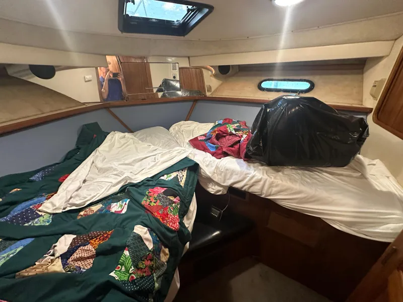 Slide: The Image of 1989 Carver 3807 Aft Cabin interior with bed and colorful quilt. - 24