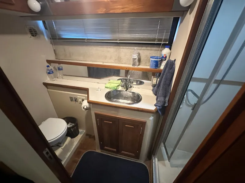 Slide: The Image of 1989 Carver 3807 Aft Cabin bathroom with sink, shower, and toilet. - 33