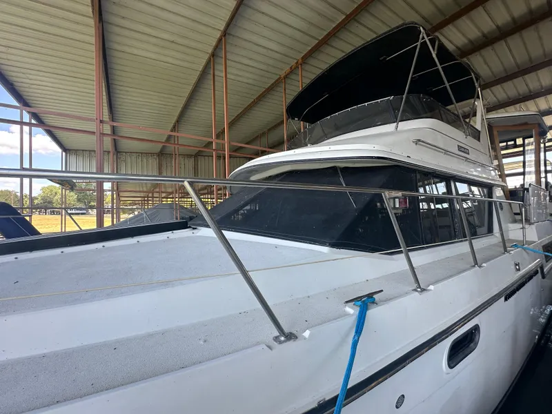 Slide: The Image of 1989 Carver 3807 Aft Cabin yacht docked in covered marina. - 5
