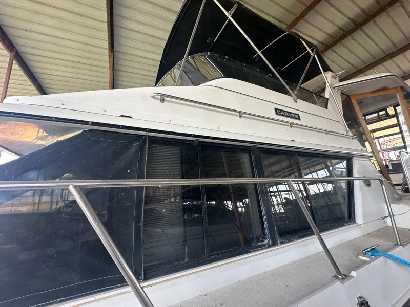 Slide: The Image of 1989 Carver 3807 Aft Cabin yacht in covered dock, side view. - 6
