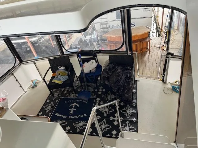 Slide: The Image of 1989 Carver 3807 Aft Cabin interior with seating and nautical decor. - 9