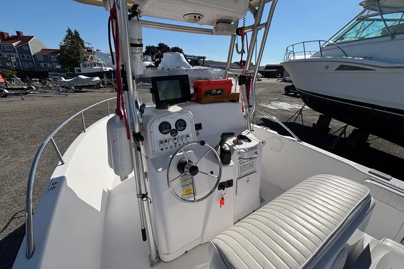 Slide: The Image of 2004 Pro-Line 20 Sport boat interior with steering console and seating. - 12