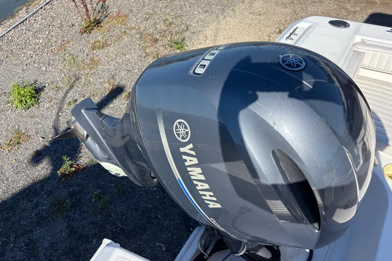 Slide: The Image of Yamaha outboard motor on 2004 Pro-Line 20 Sport boat, parked on gravel. - 13