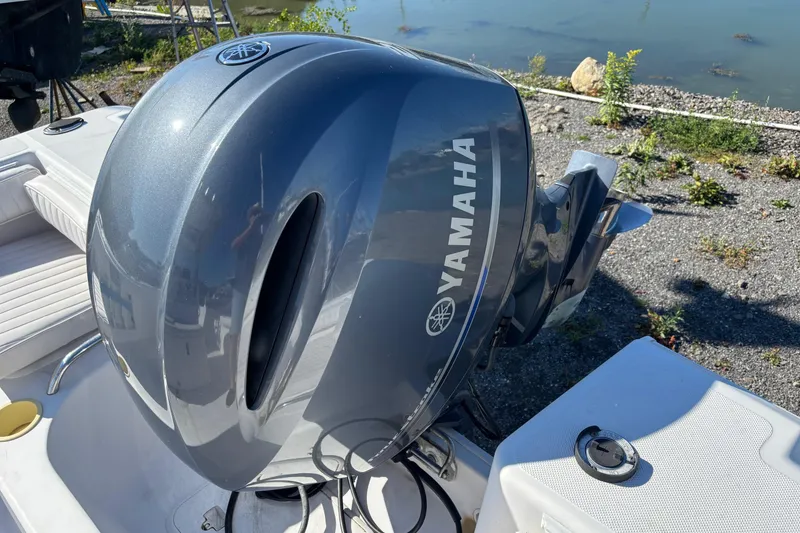 Slide: The Image of Yamaha outboard motor on 2004 Pro-Line 20 Sport boat by the water. - 14