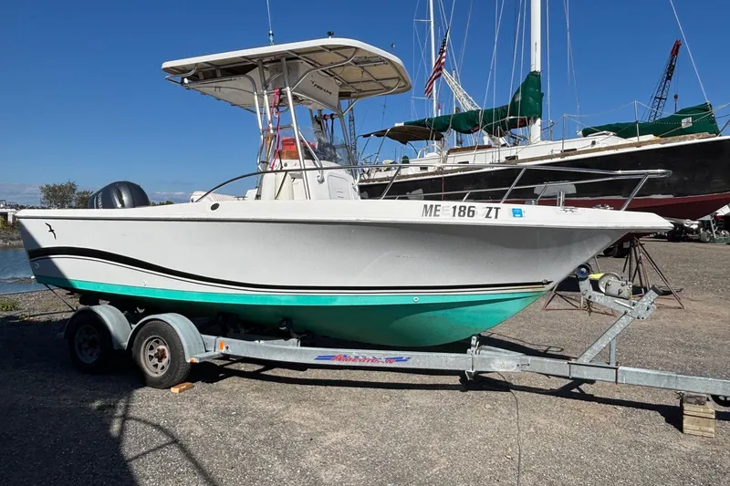 Slide: The Image of 2004 Pro-Line 20 Sport boat on trailer, parked outdoors under clear blue sky. - 4