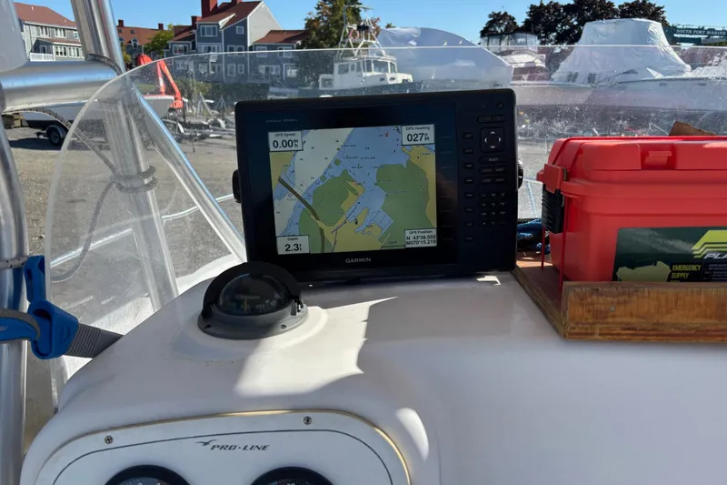 Slide: The Image of 2004 Pro-Line 20 Sport boat dashboard with Garmin GPS and emergency supply box. - 9