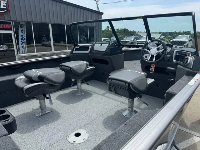Slide: The Image of 2024 Lund 1875 Impact XS Sport boat interior with seating and console. - 3