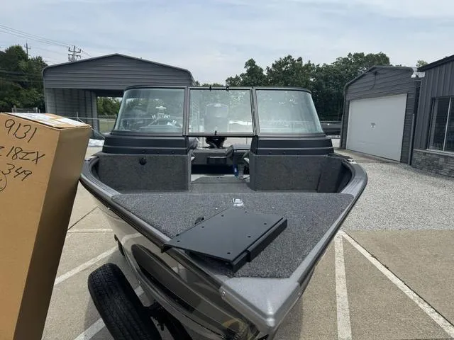 Slide: The Image of 2024 Lund 1875 Impact XS Sport boat parked outdoors. - 7