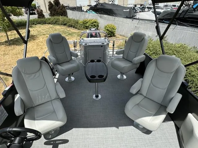 Slide: The Image of 2024 Starcraft EXS 3 HB4 boat interior with four grey captain's chairs and a central table. - 12