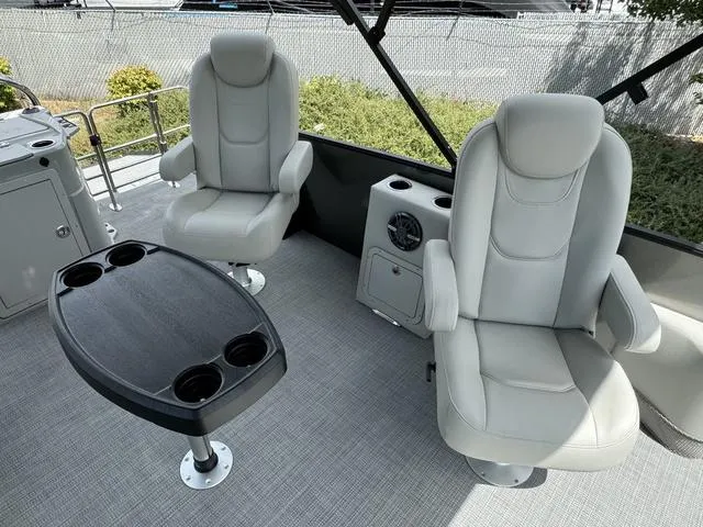 Slide: The Image of 2024 Starcraft EXS 3 HB4 boat interior with two captain's chairs and a table. - 13