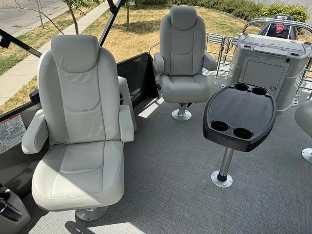 Slide: The Image of 2024 Starcraft EXS 3 HB4 boat interior with two captain's chairs and a table. - 14