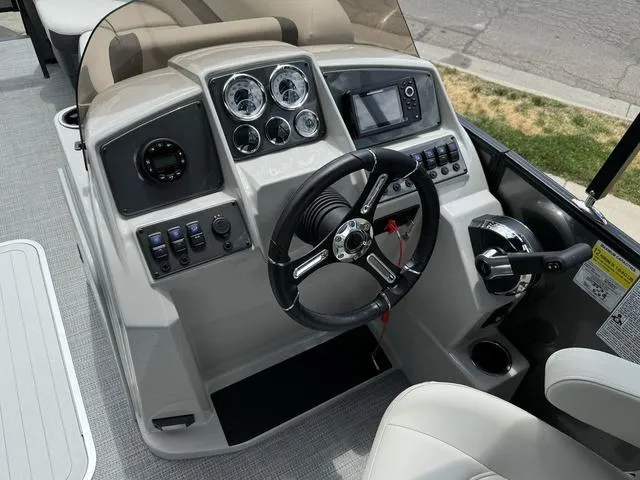 Slide: The Image of 2024 Starcraft EXS 3 HB4 boat dashboard with steering wheel, gauges, and controls. - 15