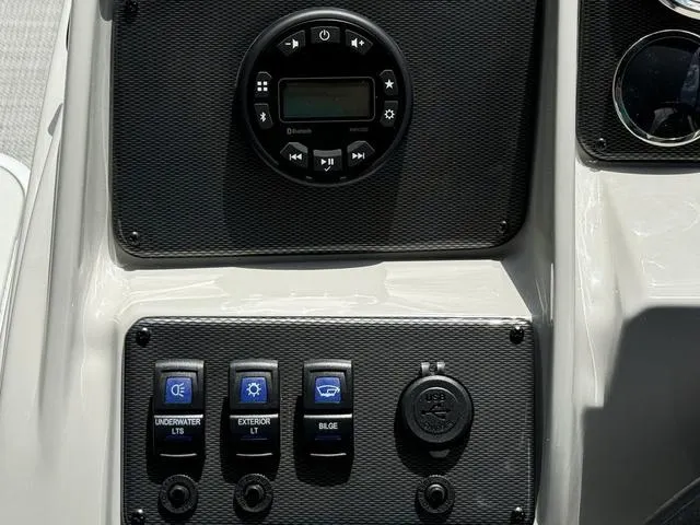 Slide: The Image of Control panel of 2024 Starcraft EXS 3 HB4 boat with switches and Bluetooth stereo. - 16