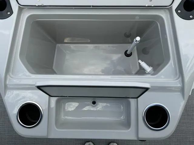 Slide: The Image of 2024 Starcraft EXS 3 HB4 boat storage compartment with cup holders. - 23