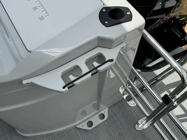 Slide: The Image of 2024 Starcraft EXS 3 HB4 boat detail showing storage compartment and rod holder. - 24