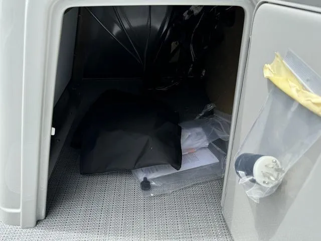 Slide: The Image of 2024 Starcraft EXS 3 HB4 storage compartment with accessories and documents. - 26