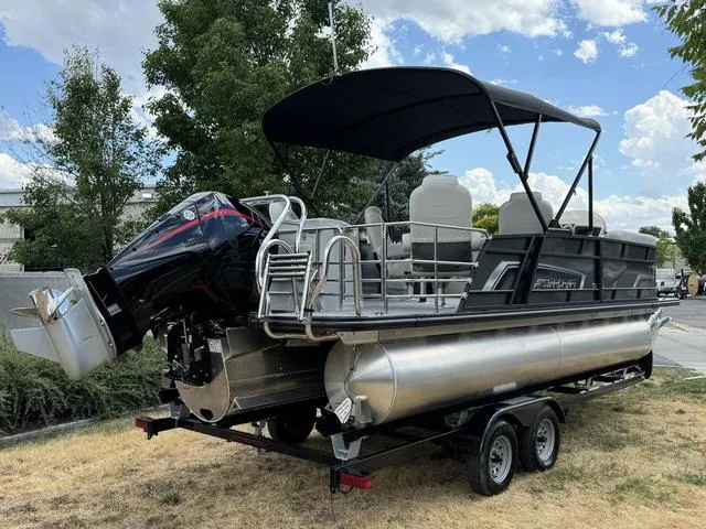 Slide: The Image of 2024 Starcraft EXS 3 HB4 pontoon boat on a trailer with outboard motor. - 3