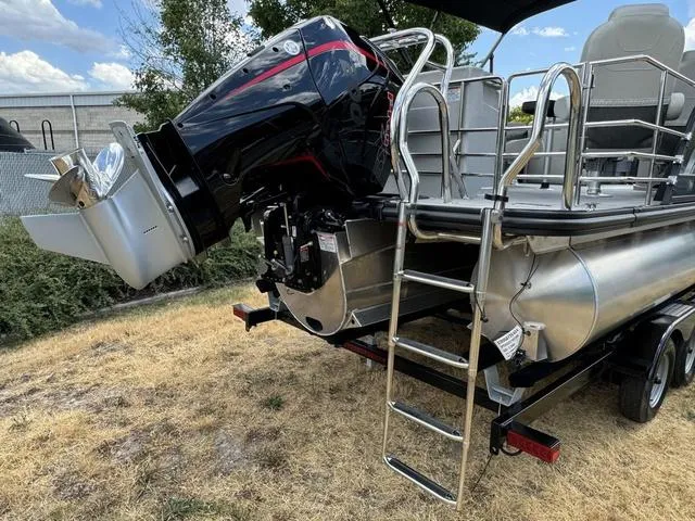 Slide: The Image of 2024 Starcraft EXS 3 HB4 pontoon boat with outboard motor and ladder. - 5