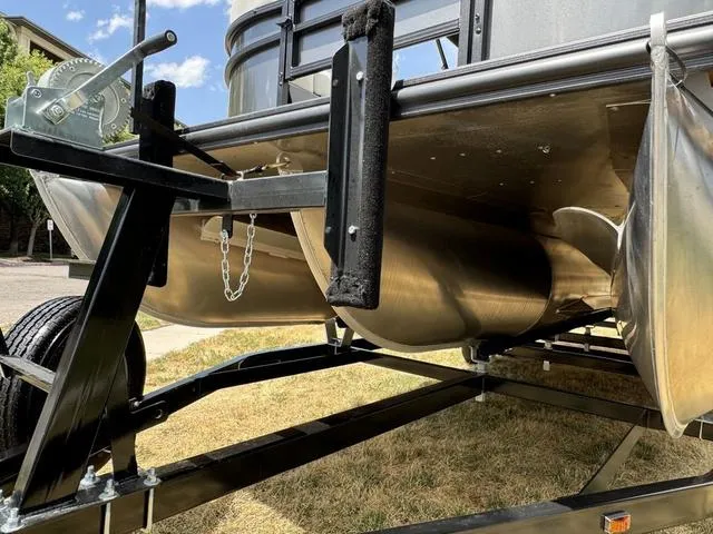 Slide: The Image of 2024 Starcraft EXS 3 HB4 pontoon boat on trailer, close-up view. - 7