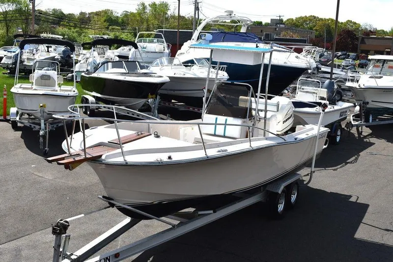 Slide: The Image of 1987 Chris-Craft 213 SeaHawk CC boat on a trailer in a marina. - 1