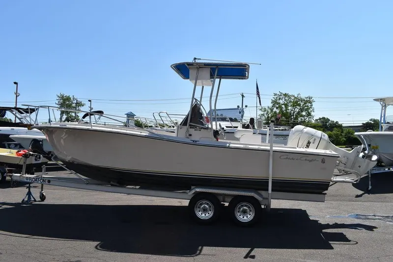 Slide: The Image of 1987 Chris-Craft 213 SeaHawk CC boat on a trailer in a parking lot. - 12