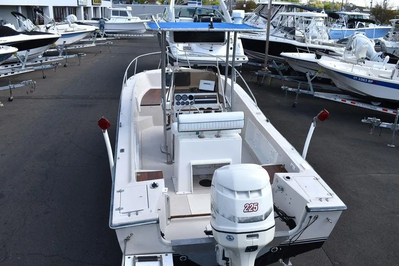 Slide: The Image of 1987 Chris-Craft 213 SeaHawk CC boat with outboard motor, docked among other boats. - 16