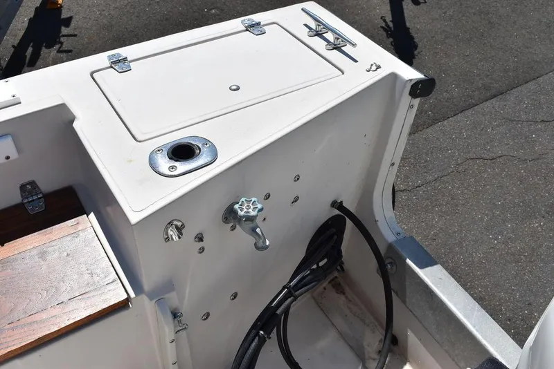 Slide: The Image of 1987 Chris-Craft 213 SeaHawk CC boat interior detail showing storage compartment and control panel. - 19