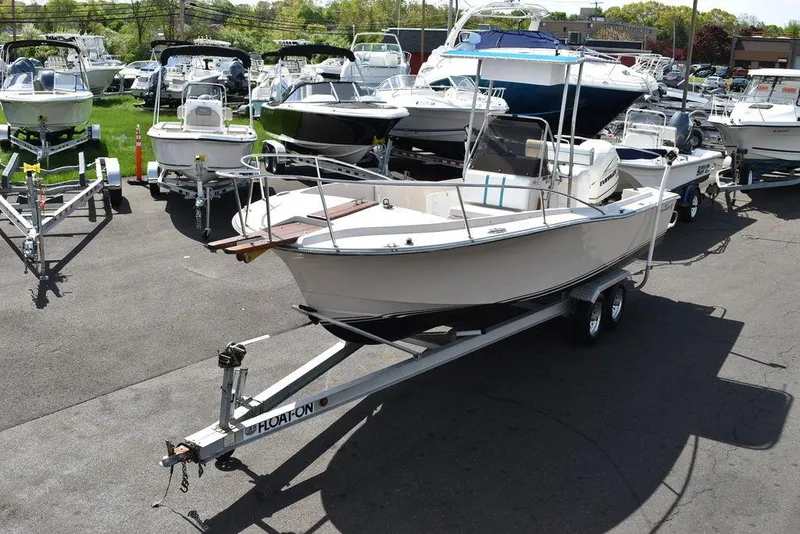 Slide: The Image of 1987 Chris-Craft 213 SeaHawk CC boat on a trailer in a marina. - 2