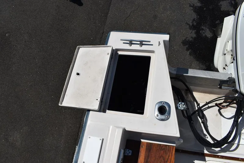 Slide: The Image of 1987 Chris-Craft 213 SeaHawk CC boat storage compartment and deck view. - 20