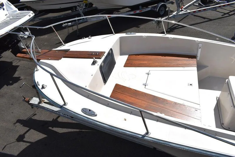 Slide: The Image of 1987 Chris-Craft 213 SeaHawk CC boat deck with wooden seating and railings. - 22
