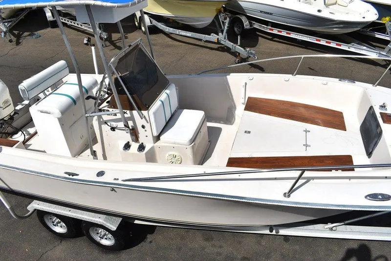 Slide: The Image of 1987 Chris-Craft 213 SeaHawk CC boat with center console and dual-axle trailer. - 25