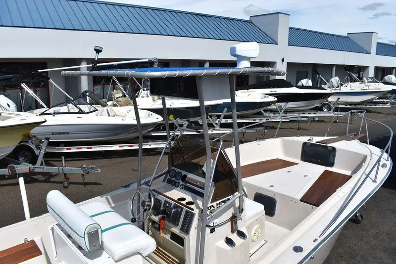 Slide: The Image of 1987 Chris-Craft 213 SeaHawk CC boat at a marina with other boats. - 26
