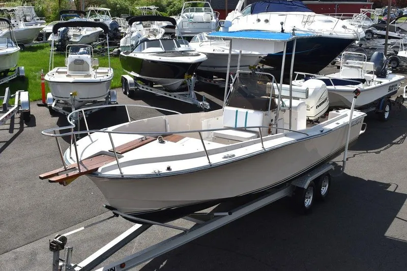 Slide: The Image of 1987 Chris-Craft 213 SeaHawk CC boat on a trailer in a marina. - 3