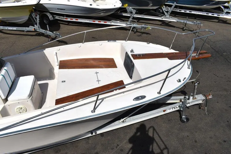 Slide: The Image of 1987 Chris-Craft 213 SeaHawk CC boat on trailer, white with wooden accents. - 34