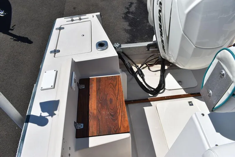 Slide: The Image of 1987 Chris-Craft 213 SeaHawk CC boat interior with wooden seat and outboard motor. - 43