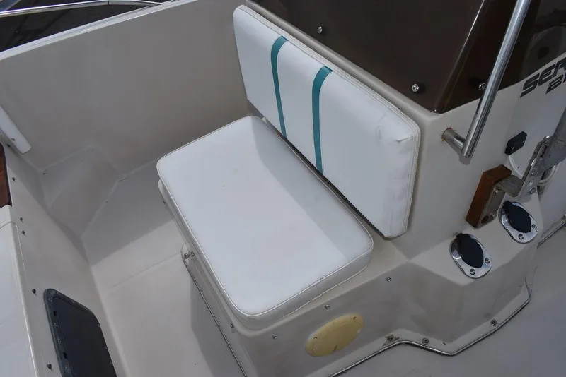 Slide: The Image of 1987 Chris-Craft 213 SeaHawk CC boat seat with white and teal cushions. - 45