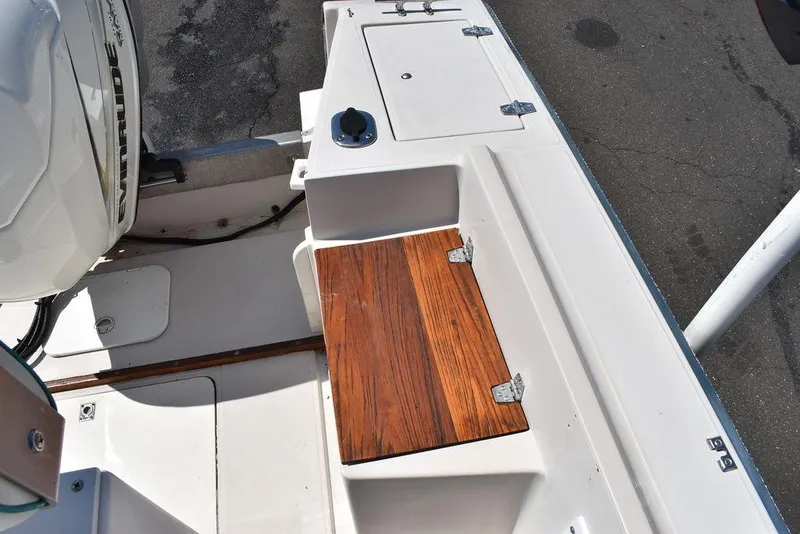 Slide: The Image of 1987 Chris-Craft 213 SeaHawk CC boat deck with wooden seat and storage compartments. - 49