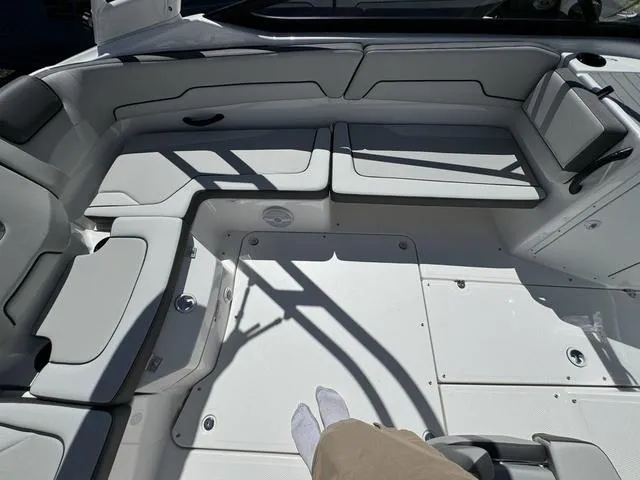 Slide: The Image of 2024 Yamaha Boats AR190 interior seating area with white and gray upholstery. - 13