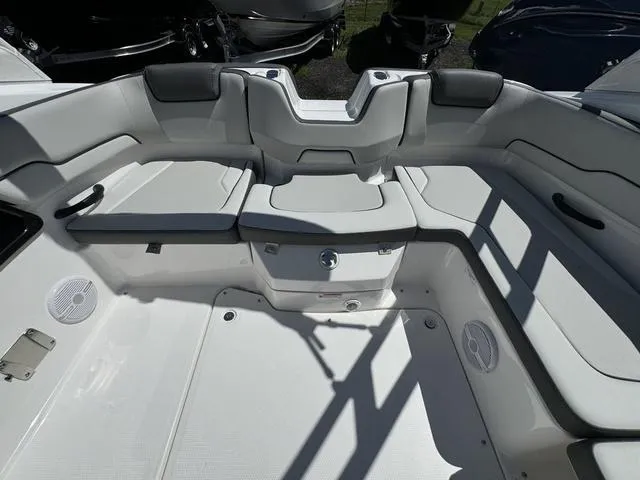 Slide: The Image of 2024 Yamaha Boats AR190 interior seating area with white and gray upholstery. - 14