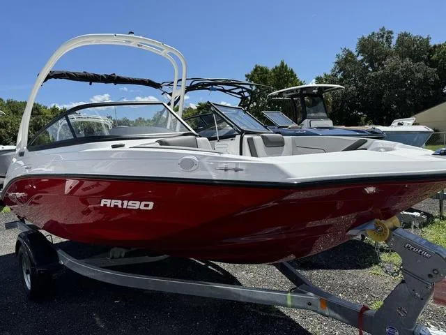 Slide: The Image of 2024 Yamaha Boats AR190 in red on a trailer, ready for water adventures. - 2